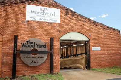 Photo of the building showing The Wood Yard sign and front loading dock